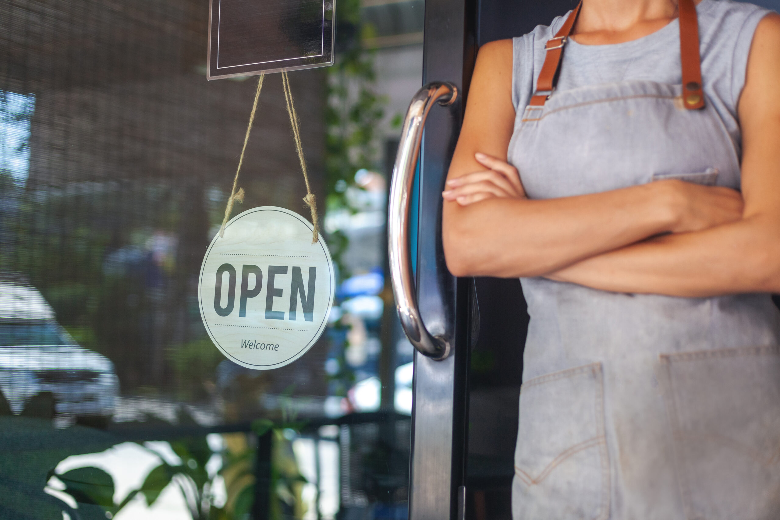 The woman is a waitress in an apron, the owner of the cafe stand